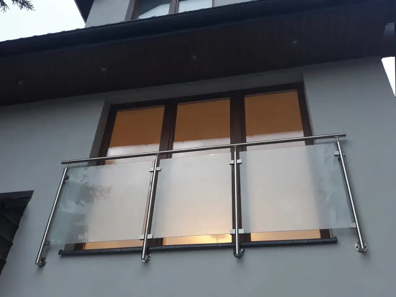 Nowoczesny balkon francuski z matowego szkła i stali nierdzewnej, idealny do podziwiania widoków.